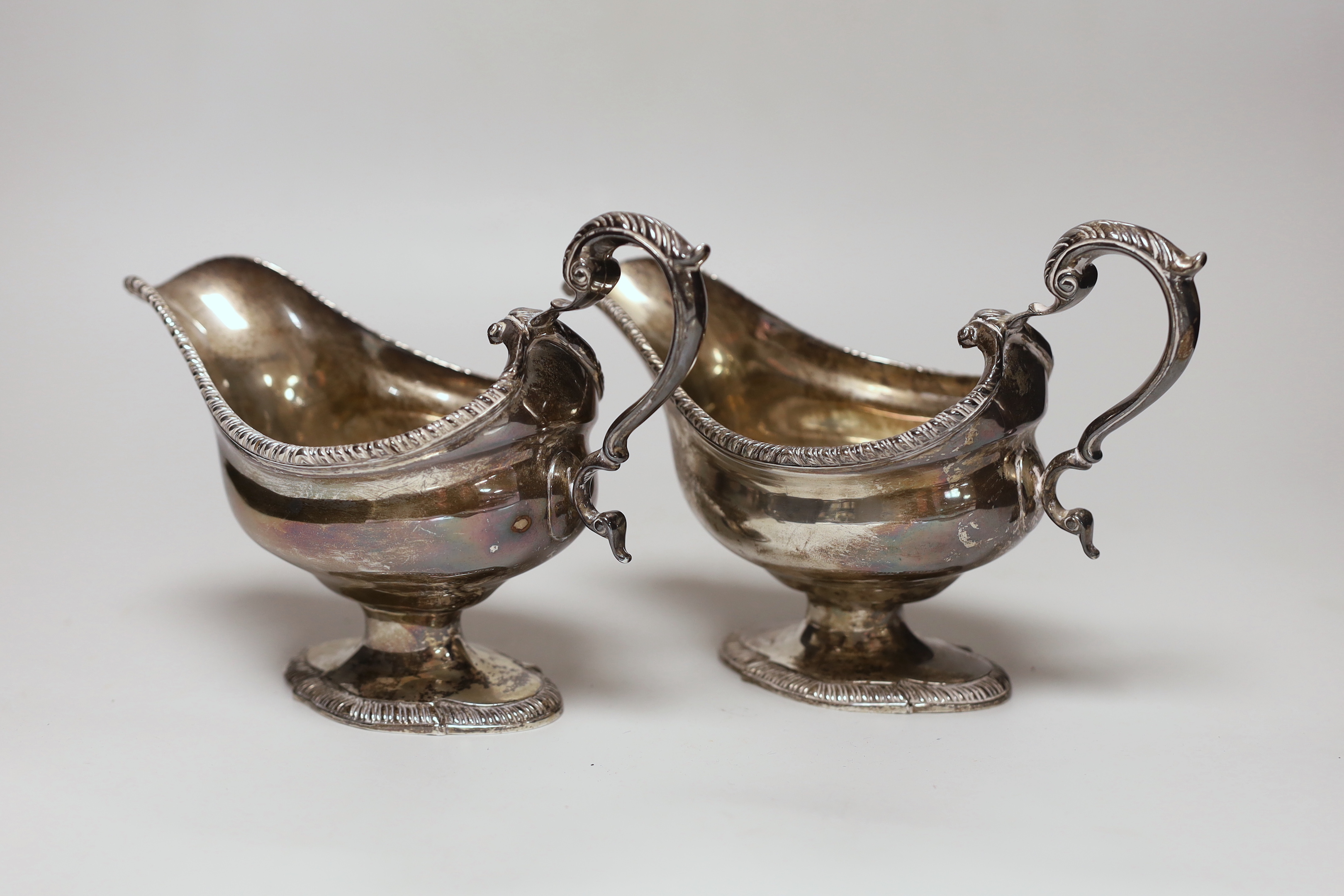A pair of George VI silver pedestal sauceboats, with gadrooned borders, S. Blanckensee & Sons Ltd, Birmingham, 1937, length 19.8cm, 23.2oz.